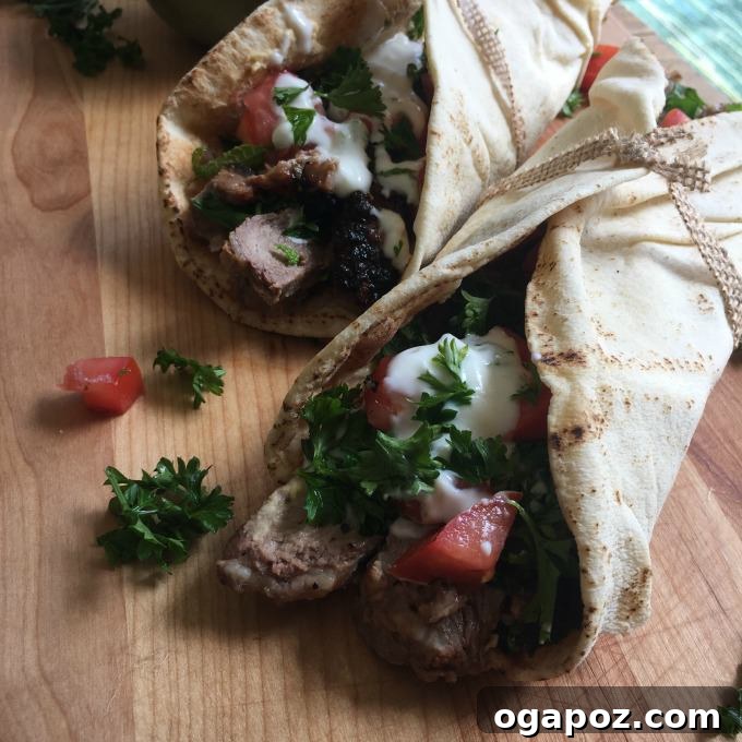Zesty Mediterranean Steak Wraps with Cool Mint Yogurt 3 Close-up of Mediterranean Steak Pita Wrap ingredients laid out, including sliced steak and fresh mint.