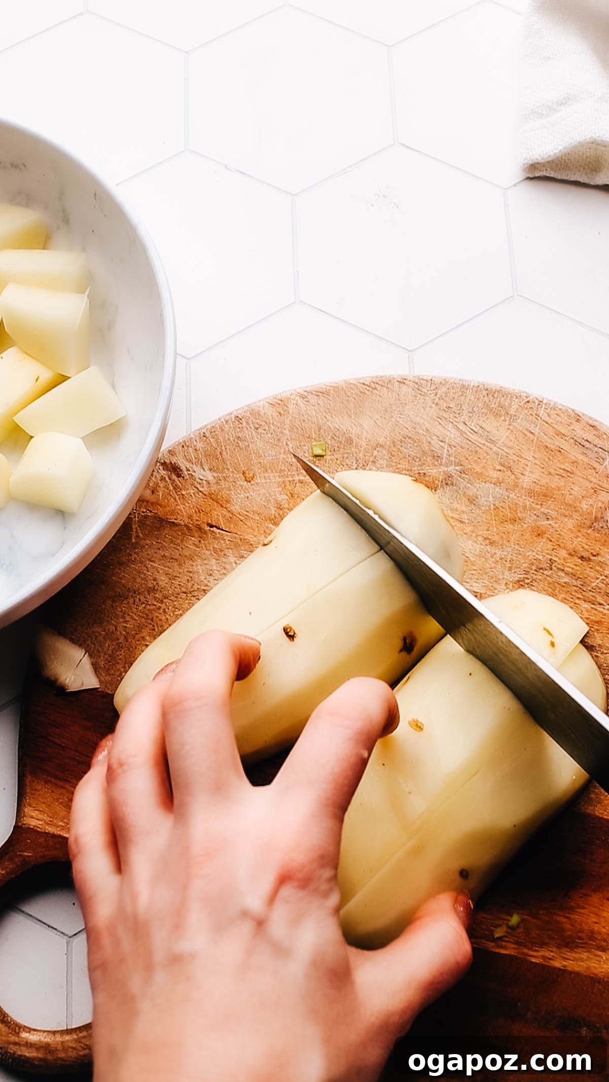 Homestyle Creamy Potato and Egg Salad 5 Chopping waxy potatoes into uniform cubes before boiling, a crucial step for evenly cooked and non-mushy potato salad.