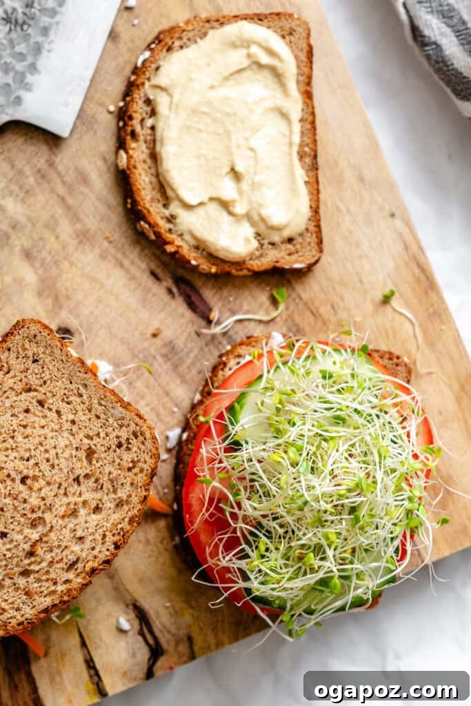 Mediterranean Vegetable Sandwich topped with fresh sprouts.
