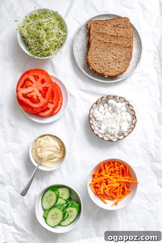 Colorful array of Mediterranean Vegetable Sandwich ingredients laid out.