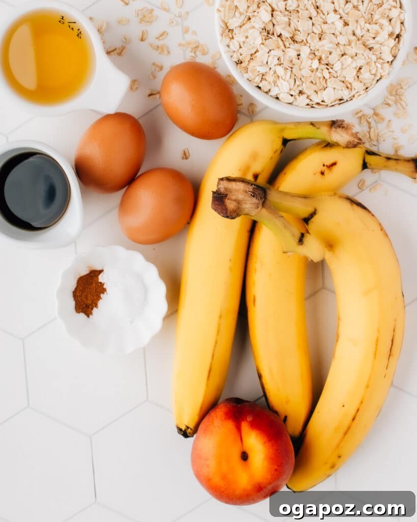 Overnight Slow-Baked Morning Oats 4 A collection of fresh ingredients for baked oatmeal, including ripe bananas, peaches, eggs, oats, and a bottle of maple syrup.