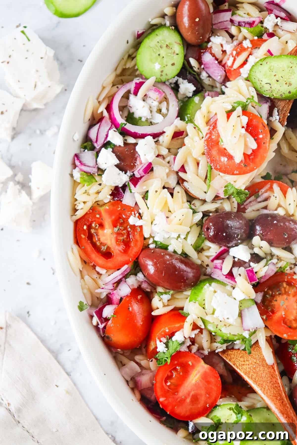 Vibrant Grecian Orzo 6 Close-up of Greek Orzo Pasta Salad, highlighting the crumbled feta cheese and fresh herbs.