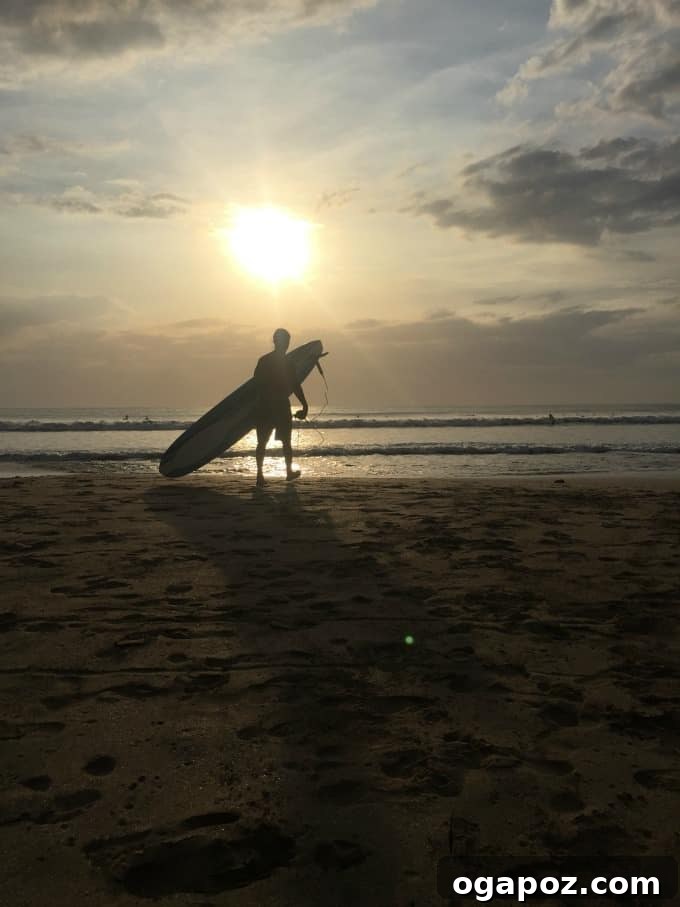 Tamarindo: Costa Rica's Pacific Paradise 5 Silhouette of a surfer carrying a board at sunset on Tamarindo Beach