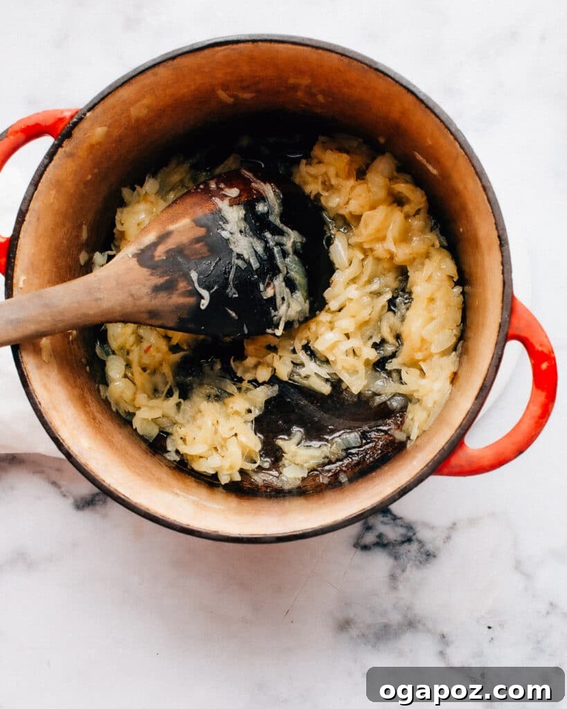 Simplified Chicken Biryani 4 Sautéed onions, golden and fragrant, form the aromatic base for the shortcut chicken biryani in a Dutch oven.