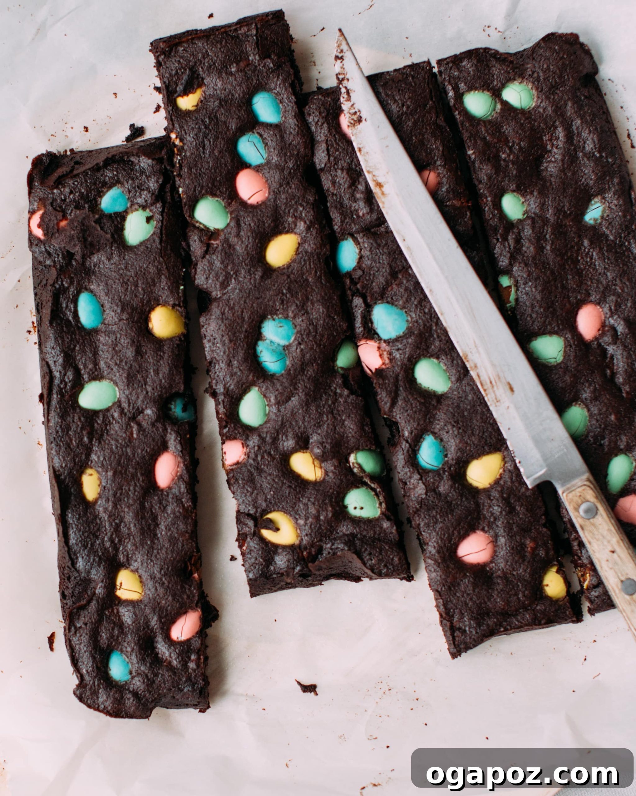 Hoppy Easter Brownies 2 Easter brownies sliced into long strips with easter eggs on them, showing their gooey texture.