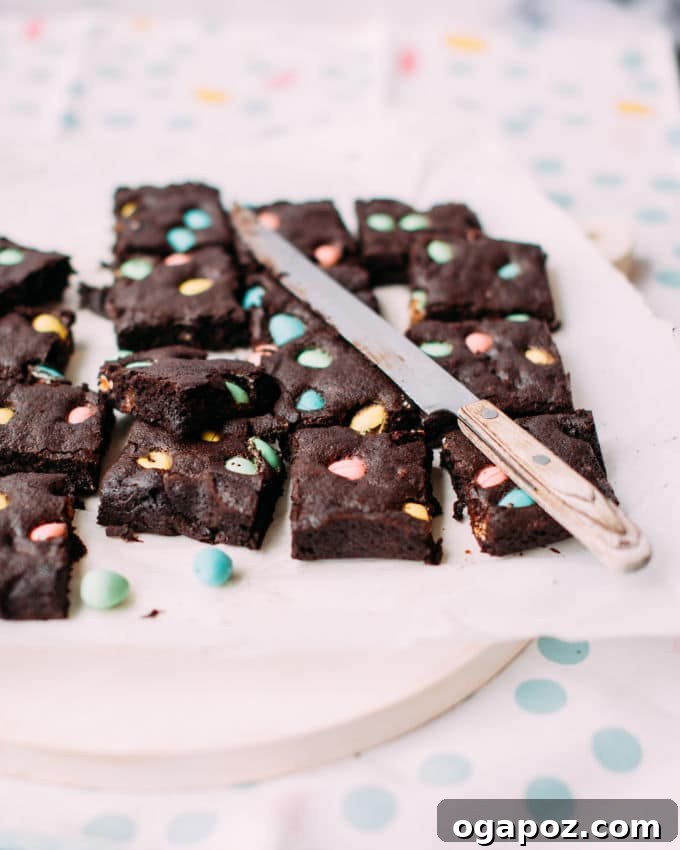 Hoppy Easter Brownies 5 Close-up of baked Easter brownies, perfectly sliced into long strips and adorned with colorful mini Easter eggs.