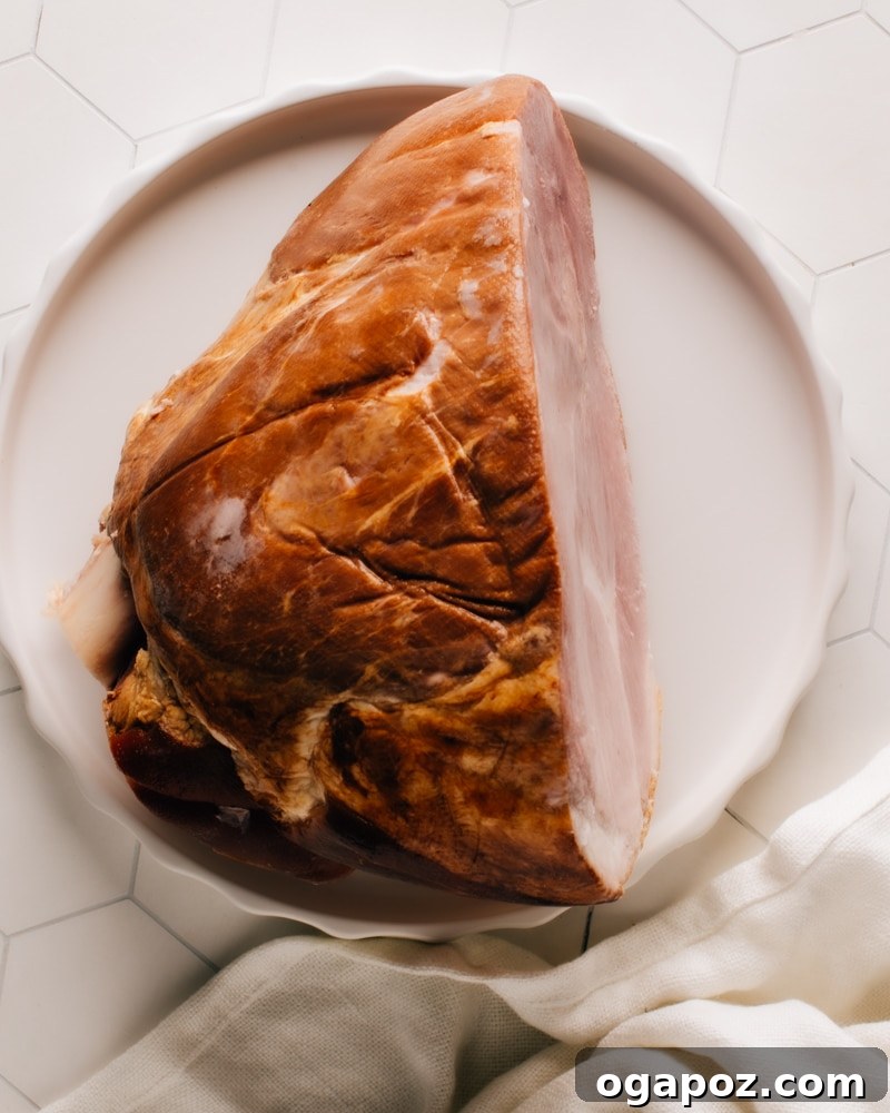 Simple ingredients for pressure cooker ham: a large ham and a liquid in a measuring cup, ready for cooking.
