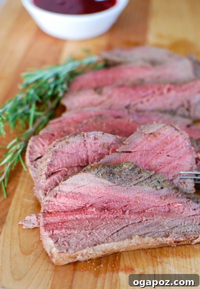 Close-up of a perfectly cooked Beef Tenderloin with Cranberry Orange Relish, showcasing its delicious appeal