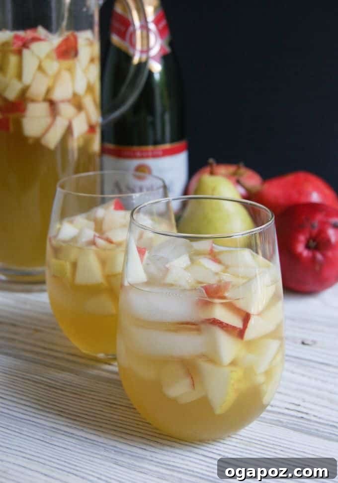 Bubbly Apple Pear Sangria 5 A close-up of a glass of sangria, showcasing the vibrant colors of the fruit and the sparkling liquid, reminiscent of Spanish warmth.