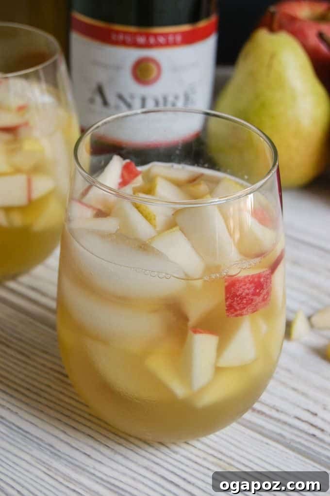 Bubbly Apple Pear Sangria 6 A beautiful spread of fall-themed appetizers and a pitcher of sparkling apple pear sangria, inviting guests to enjoy.