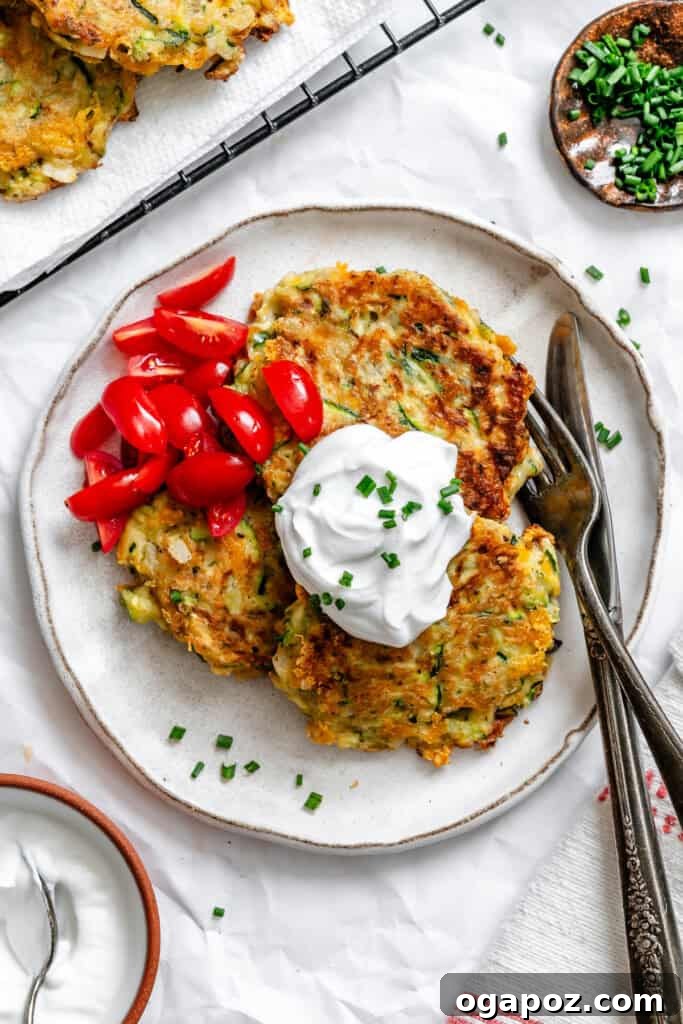Crispy Zucchini Fritters Made Easy 12 Easy Zucchini Fritters on white plate
