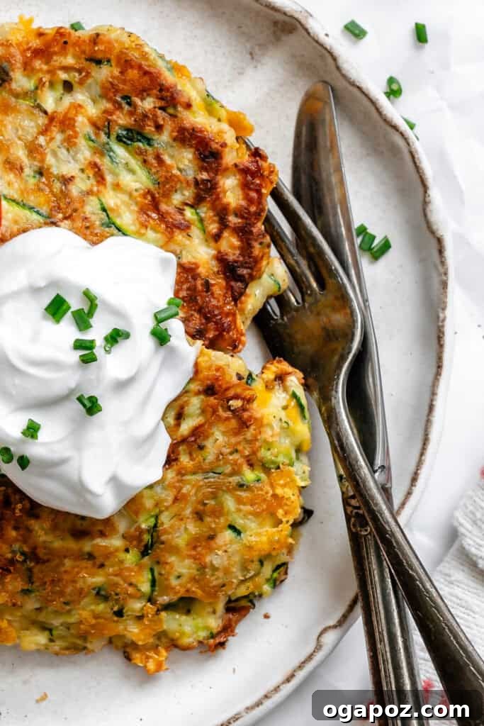 Crispy Zucchini Fritters Made Easy 7 Easy Zucchini Fritters on white plate with forks