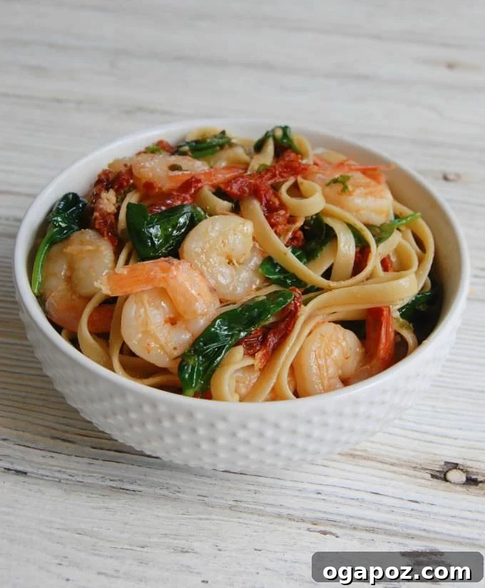 Effortless Garlic Shrimp Scampi 2 Easy Shrimp Scampi Recipe in a white bowl, garnished with fresh parsley and lemon.