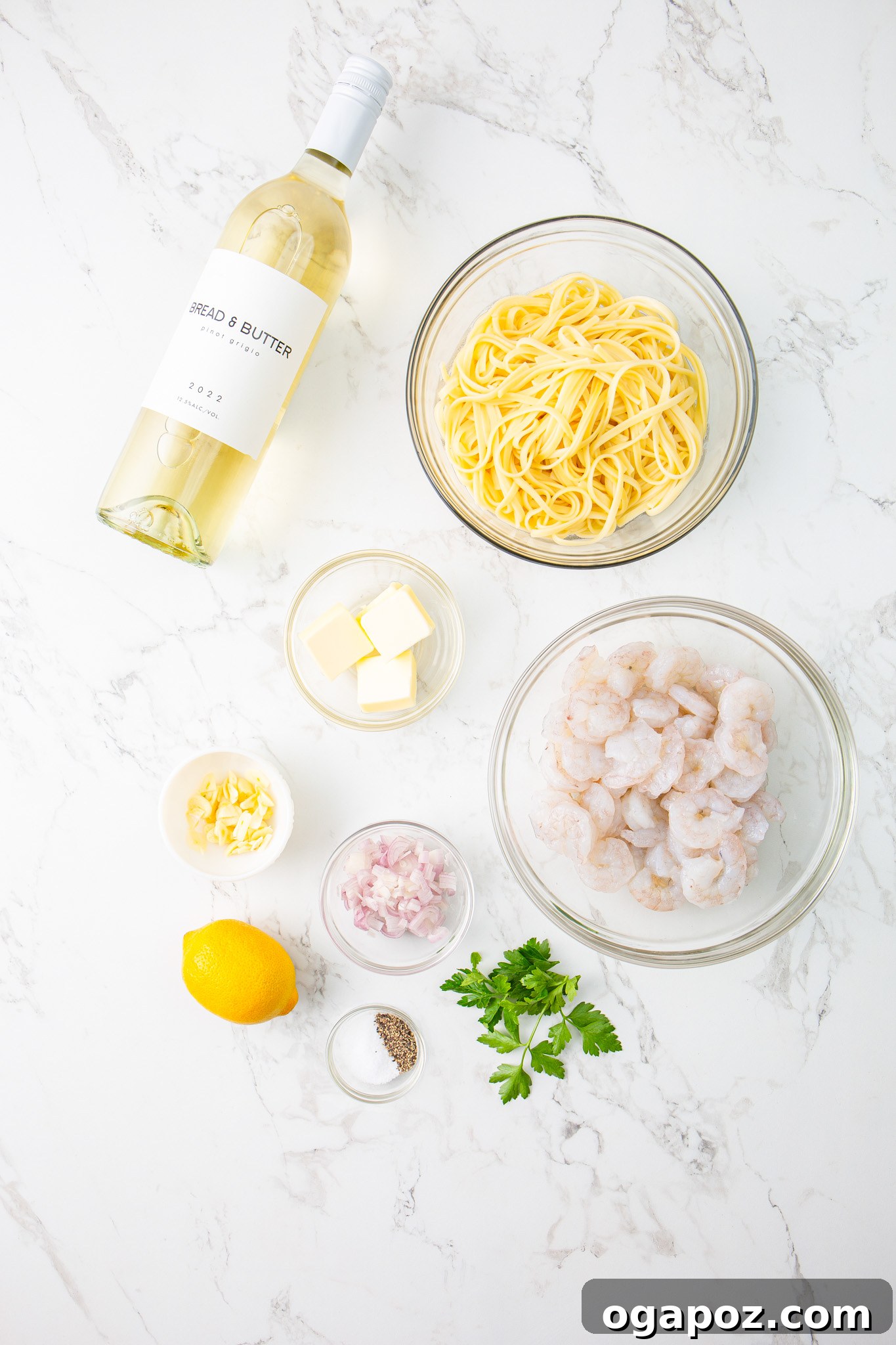 Effortless Garlic Shrimp Scampi 3 Fresh ingredients laid out for Lemon Garlic Shrimp Pasta, including lemons, garlic, fresh parsley, and pasta.