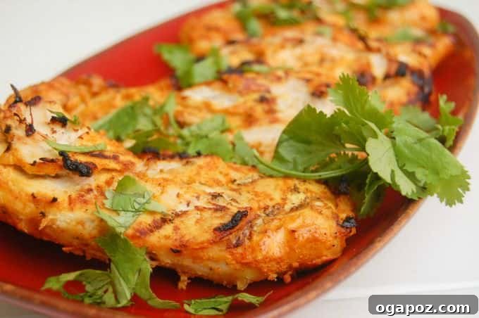 Smoky Tandoori Grilled Chicken 6 Close-up of Tandoori Grilled Chicken on a serving platter, showing the crispy exterior and rich color.