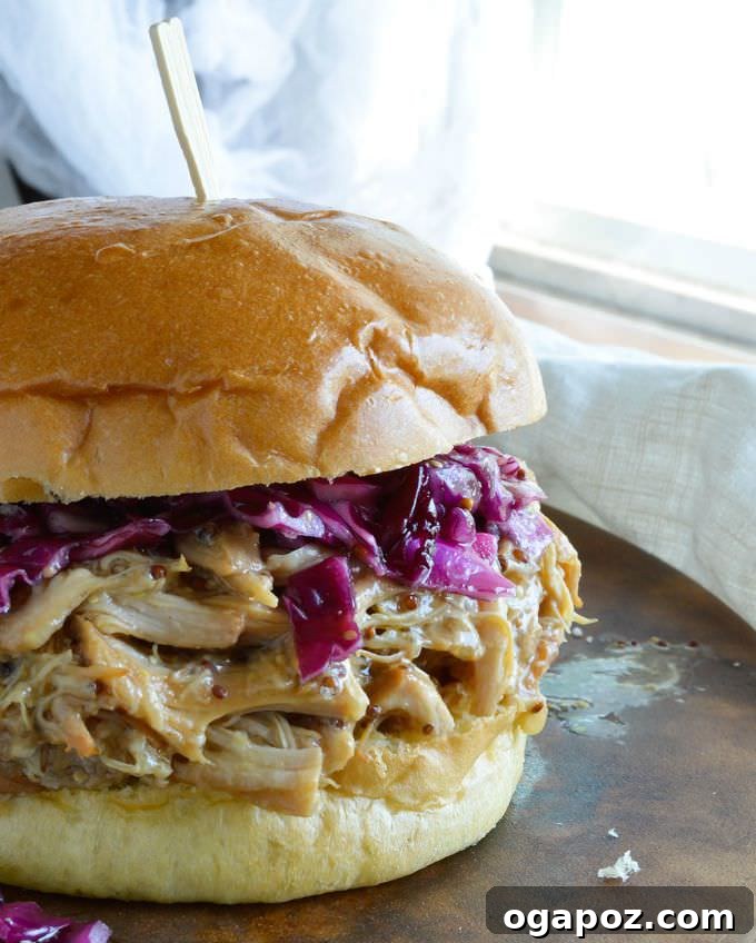 Effortless Slow Cooker Dinners for Busy School Nights 4 Delicious honey mustard shredded chicken sandwiches piled high on buns, with a side of fresh greens, ready for a meal.