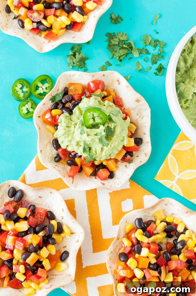 12 Superfood Avocado Recipes 4 Guacamole Tacos with Southwestern Veggie Salsa, featuring crispy taco shells filled with creamy guacamole and a colorful, spicy vegetable salsa.