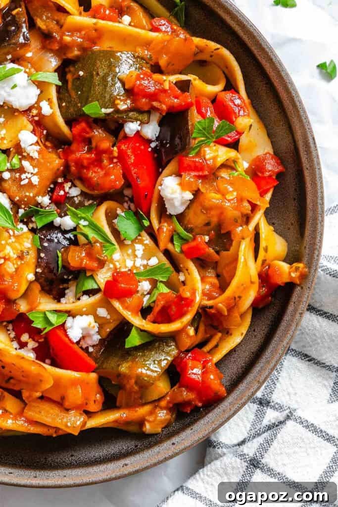 Provencal Garden Pappardelle 7 A generous serving of Ratatouille Pappardelle, elegantly garnished with fresh feta cheese and parsley, ready to be savored.