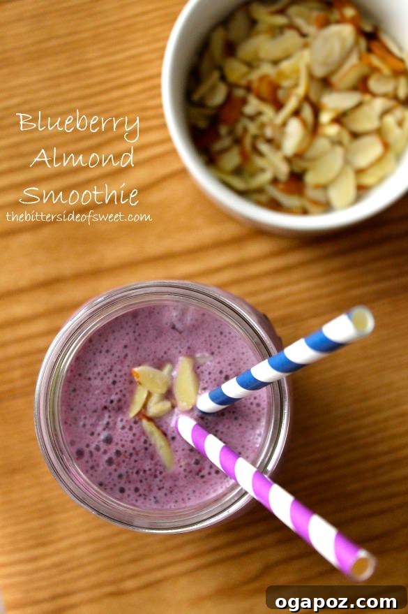9 Amazing Blueberry Superfood Smoothies 4 A creamy Blueberry Almond Smoothie served in a tall glass, with a light sprinkle of slivered almonds on top, showcasing its rich texture and inviting appearance.