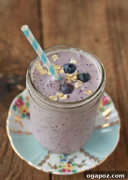 9 Amazing Blueberry Superfood Smoothies 9 A thick and creamy Blueberry Oatmeal Smoothie in a glass, illustrating its hearty and fulfilling texture, ideal for a nutritious meal.