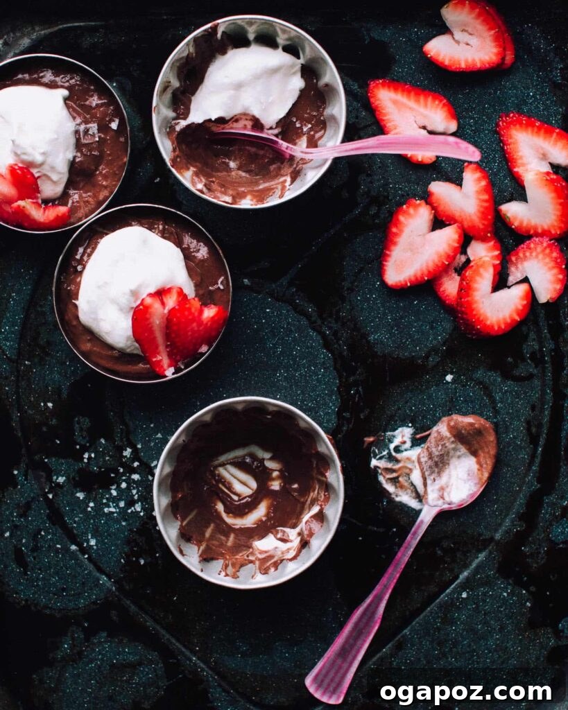 Effortless Chocolate Christmas Delights 21 A bowl of rich Salted Double Chocolate Pudding, garnished with fresh sliced strawberries on top.