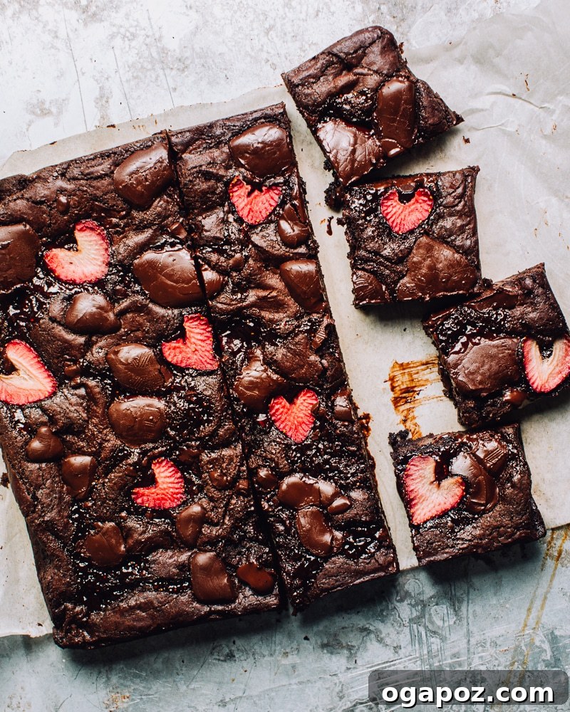 Effortless Chocolate Christmas Delights 7 Decadent Strawberry Brownies topped with fresh strawberries and a strawberry jam swirl.