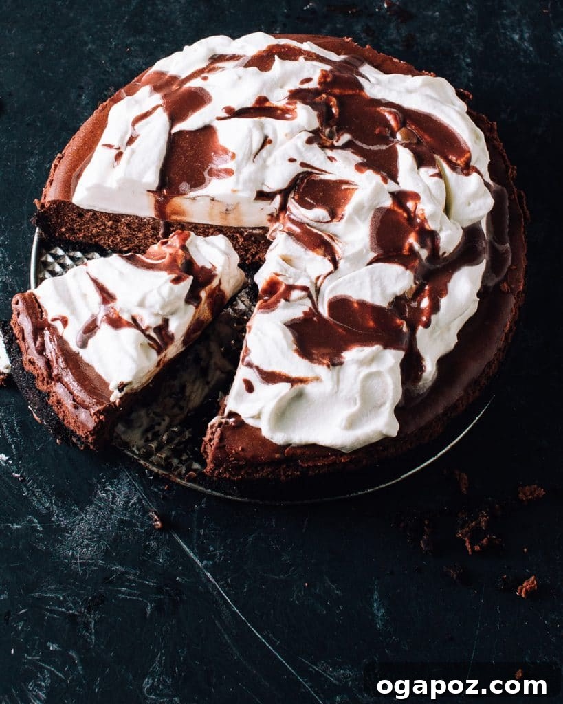Effortless Chocolate Christmas Delights 9 A glorious Chocolate Cheesecake with a chocolate wafer crust and a fluffy cream cheese filling, adorned with whipped cream.