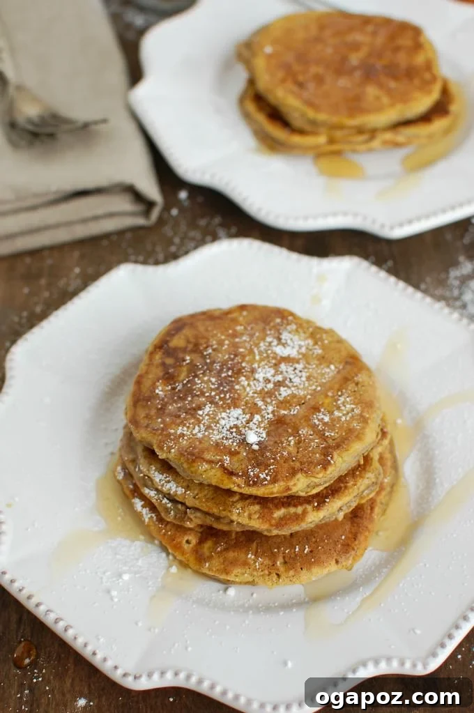 Autumn's Pumpkin Spice Stacks 4 Close-up of a stack of Pumpkin Pie Pancakes with whipped cream and spices