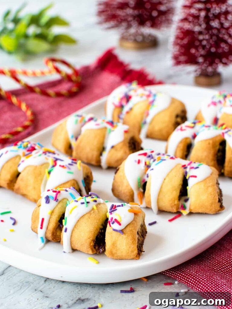 15 Italian Christmas Dessert Delights 16 Beautifully decorated Italian fig cookies (Cuccidati) arranged on a plate, showcasing their festive designs.