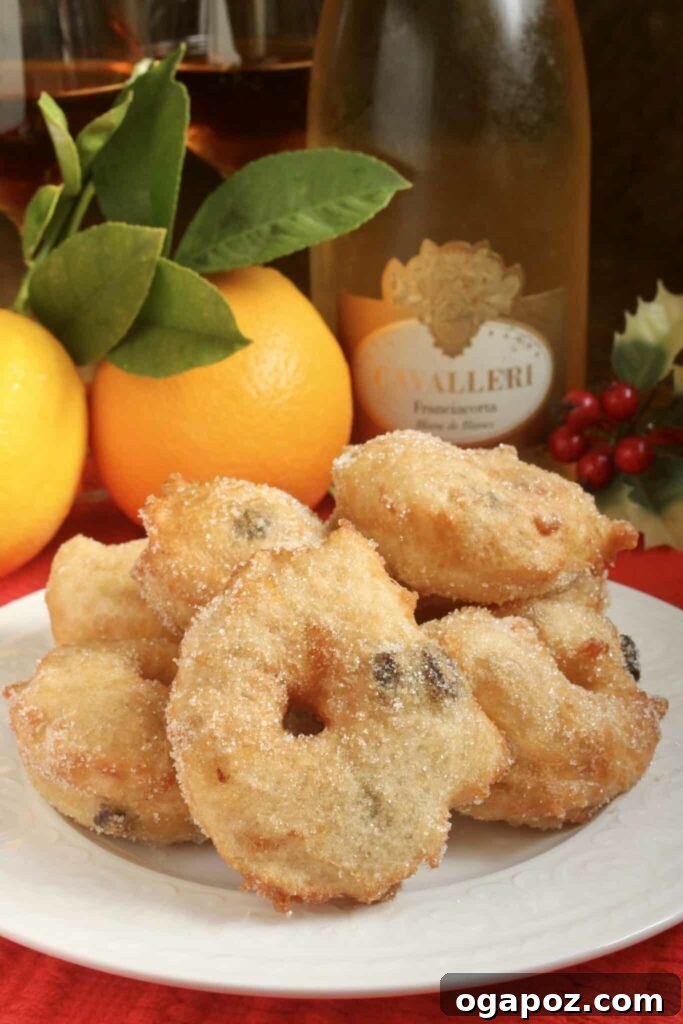 15 Italian Christmas Dessert Delights 6 A generous stack of golden-brown Zeppoles, lightly dusted with powdered sugar, piled high on a plate, ready to be enjoyed.