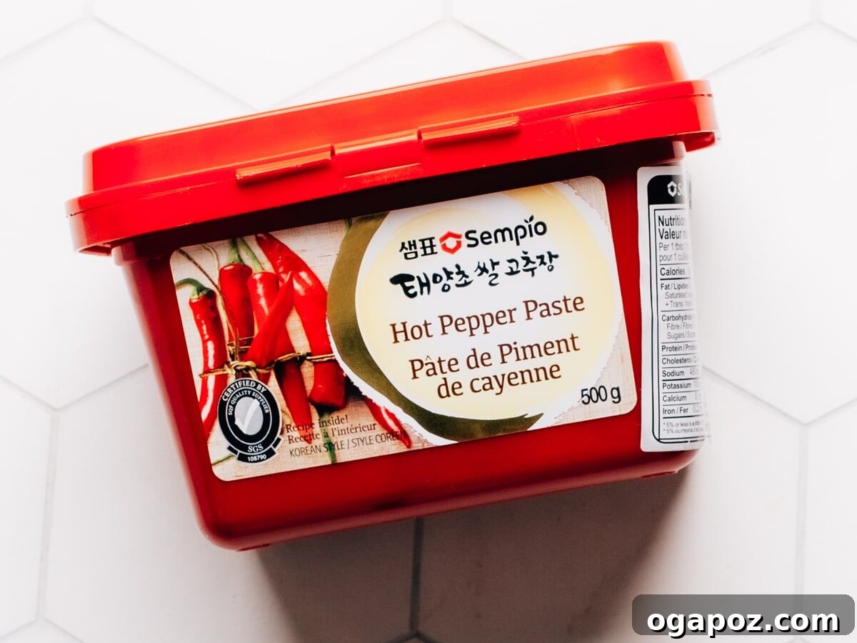 A vibrant red container of authentic Gochujang paste, highlighting the label.
