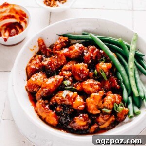 Gochujang chicken and green beans in a shallow bowl ready to enjoy.