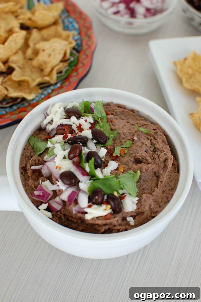 Black Bean Dip with Queso Fresco in a serving bowl with chips
