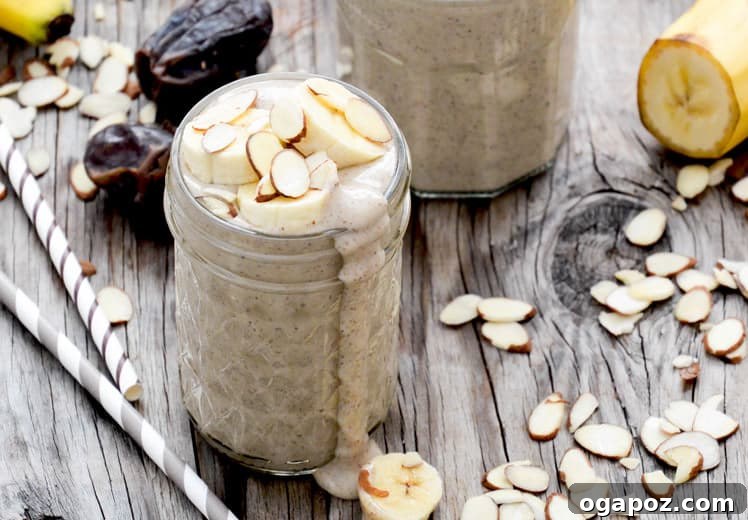 Creamy Roasted Banana and Almond Smoothie in a glass, topped with nuts