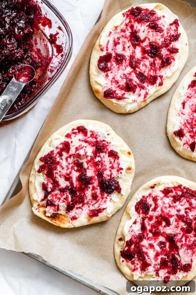 Sweet and Tart Brie Cranberry Naan 11 Cranberry sauce being spooned onto naan with brie