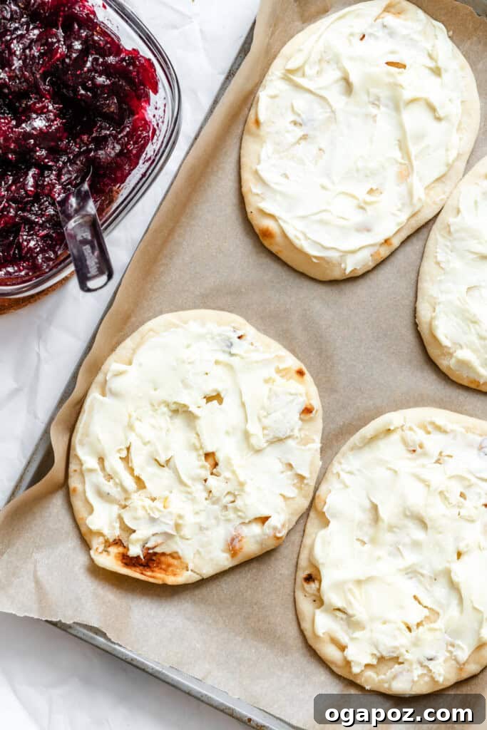 Sweet and Tart Brie Cranberry Naan 10 Brie cheese being spread on naan bread