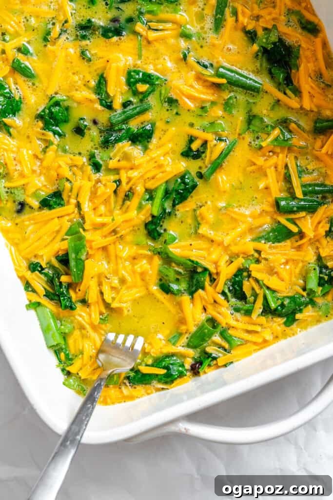 Tex-Mex Black Bean Egg Casserole with Zesty Verde 11 Egg mixture poured over the layered ingredients in the baking dish, prior to baking.