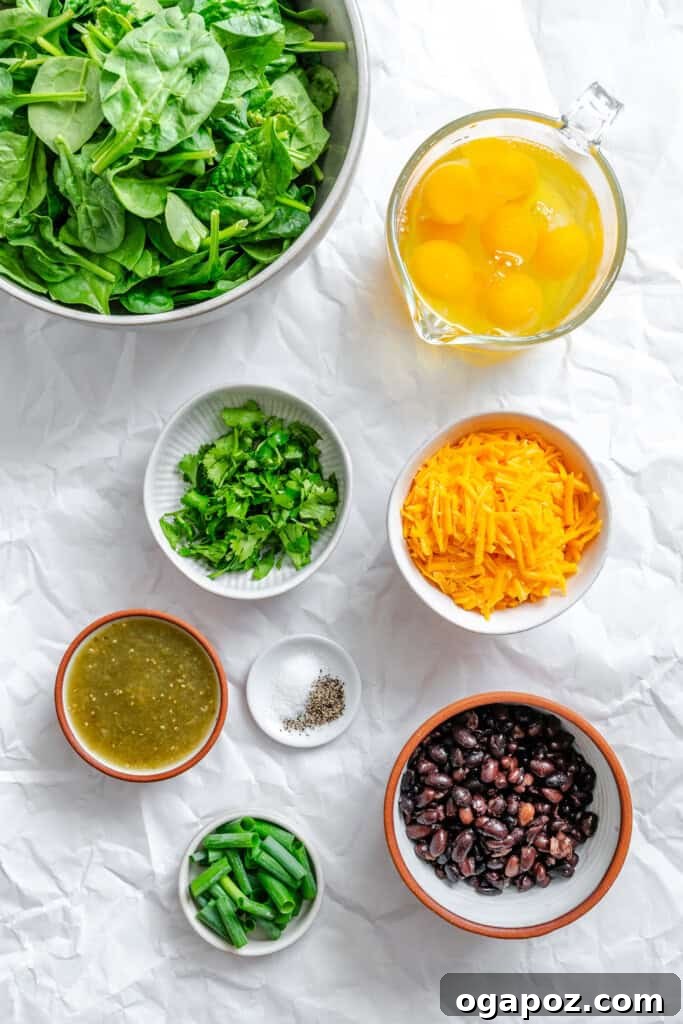 Tex-Mex Black Bean Egg Casserole with Zesty Verde 5 All the fresh ingredients laid out for the Cheesy Black Bean Egg Bake recipe, including eggs, spinach, black beans, and salsa verde.