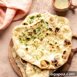 Warm butter naan with a dish of melted butter.