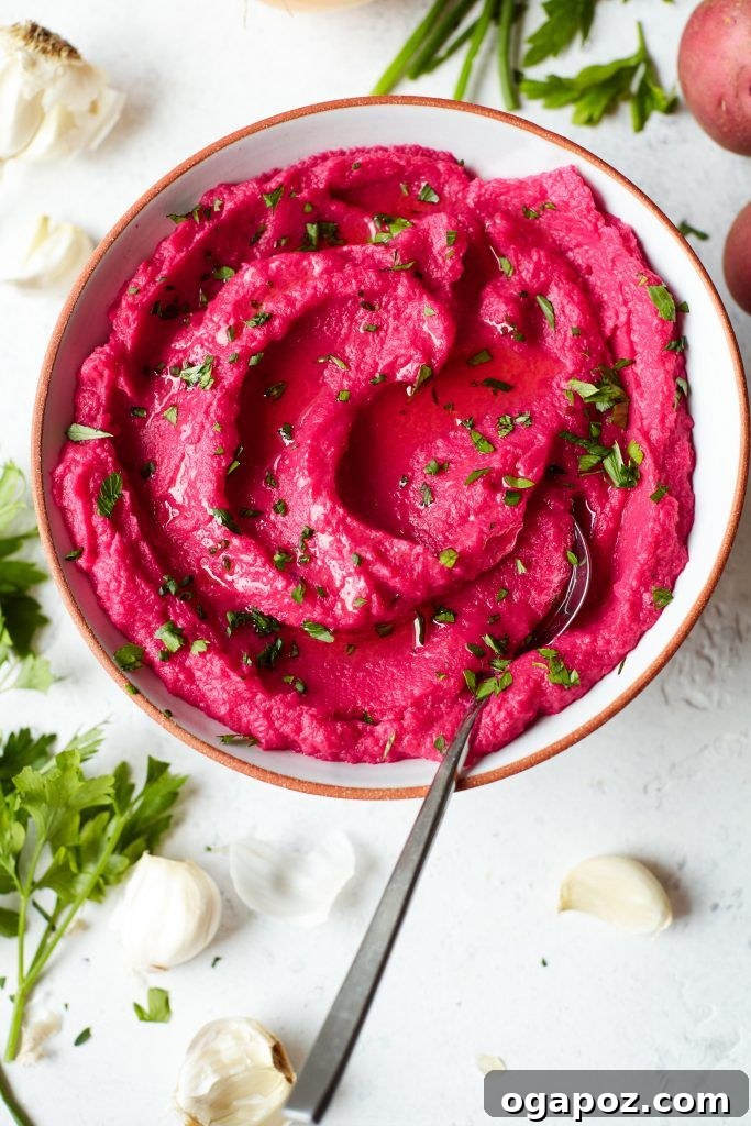 14+ Effortless Valentine's Day Family Feasts 18 A ceramic bowl of vibrant Beet Mashed Potatoes, garnished with fresh cilantro, perfect for a family Valentine's Day dinner.
