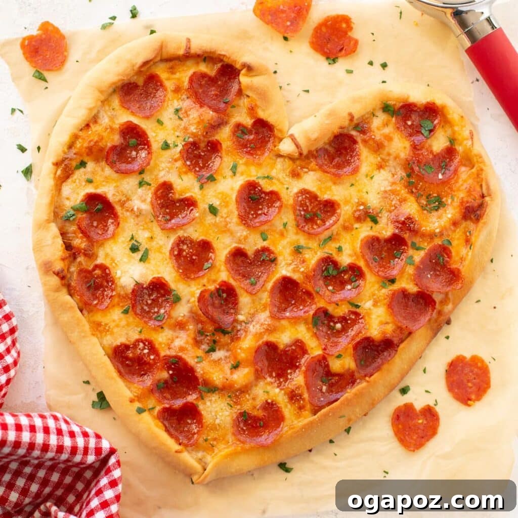14+ Effortless Valentine's Day Family Feasts 15 Adorable Heart-shaped pizza topped with melted cheese and pepperoni, perfect for Valentine's Day.