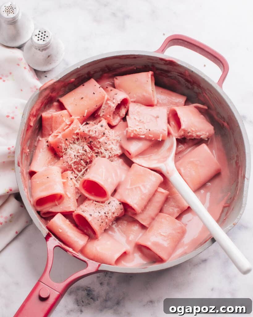 14+ Effortless Valentine's Day Family Feasts 3 Vibrant Beet Pasta Sauce coating a plate of pasta, ready to serve.