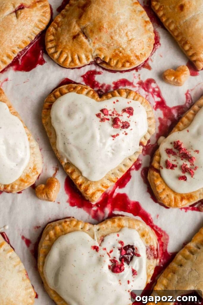 14+ Effortless Valentine's Day Family Feasts 22 Beautiful Valentine's Day Raspberry Hand Pies, elegantly drizzled with white chocolate.