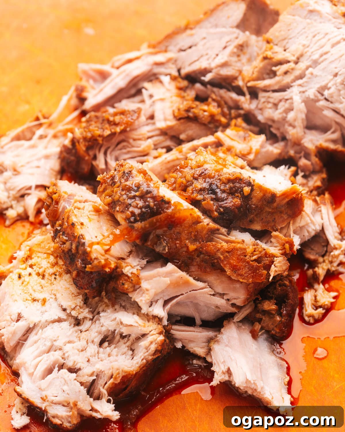 14+ Effortless Valentine's Day Family Feasts 4 Perfectly sliced, tender slow cooker pork loin on a wooden cutting board, ready to be served.