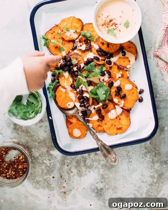 15 Easy Game Day Nachos Crowd Favorites 2 Sweet potato nachos served in a ceramic dish with cheese sauce and a happy kid reaching for a piece
