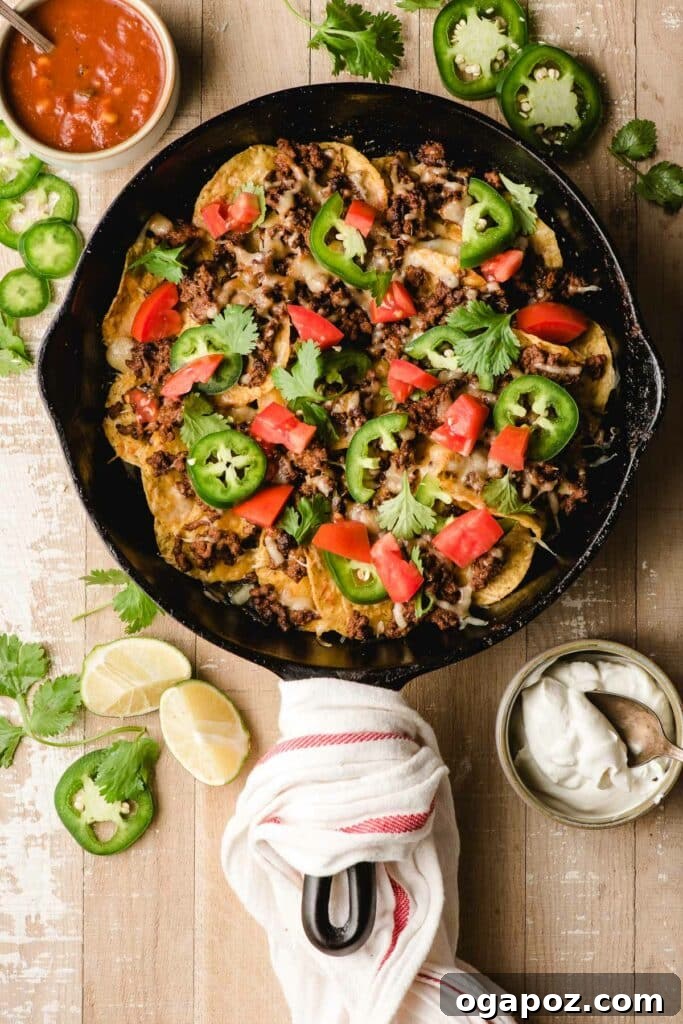 15 Easy Game Day Nachos Crowd Favorites 4 Ground Beef Nachos in a sizzling cast iron skillet, served with a dip on the side