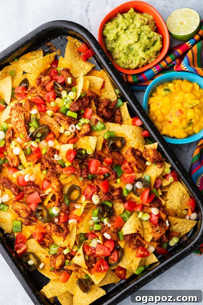 15 Easy Game Day Nachos Crowd Favorites 7 A top view of BBQ chicken nachos, topped with melted cheese, jalapenos, and salsa