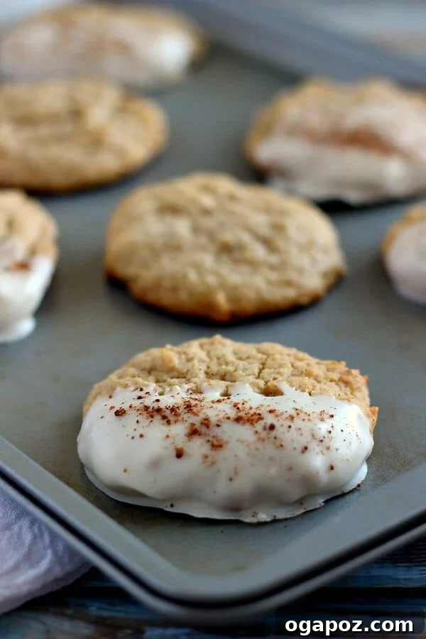 23 Essential Holiday Cookies to Bake This Season 18 Soft eggnog cookies partially dipped in smooth, sweet white chocolate, creating a festive contrast.