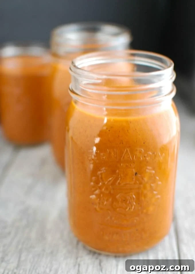 Perfect Homemade Enchilada Sauce 5 A mason jar filled with freshly made homemade enchilada sauce, ready for use.