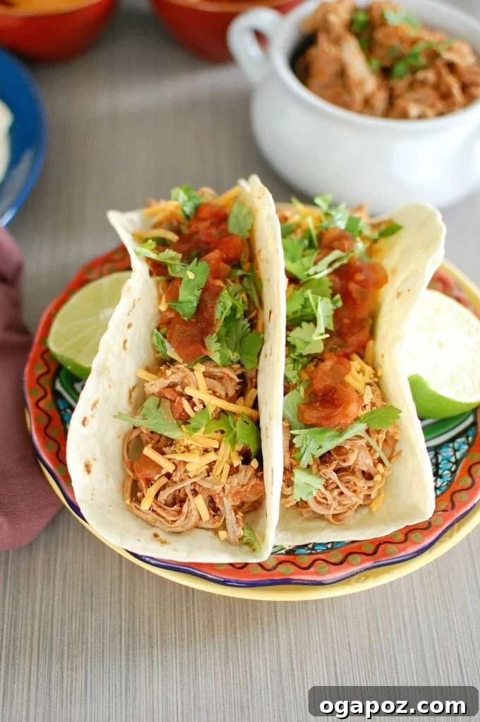 Fall-Apart Slow Cooker Pork Tacos 4 Slow Cooker Shredded Pork Tacos - a close-up of the cooked, shredded pork in the slow cooker, ready for tacos.